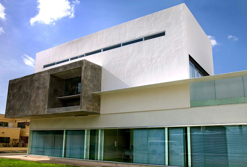 AS arquitectura fits three different offices into a concrete cube