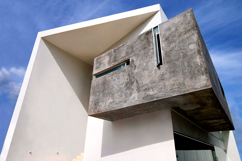 AS arquitectura fits three different offices into a concrete cube