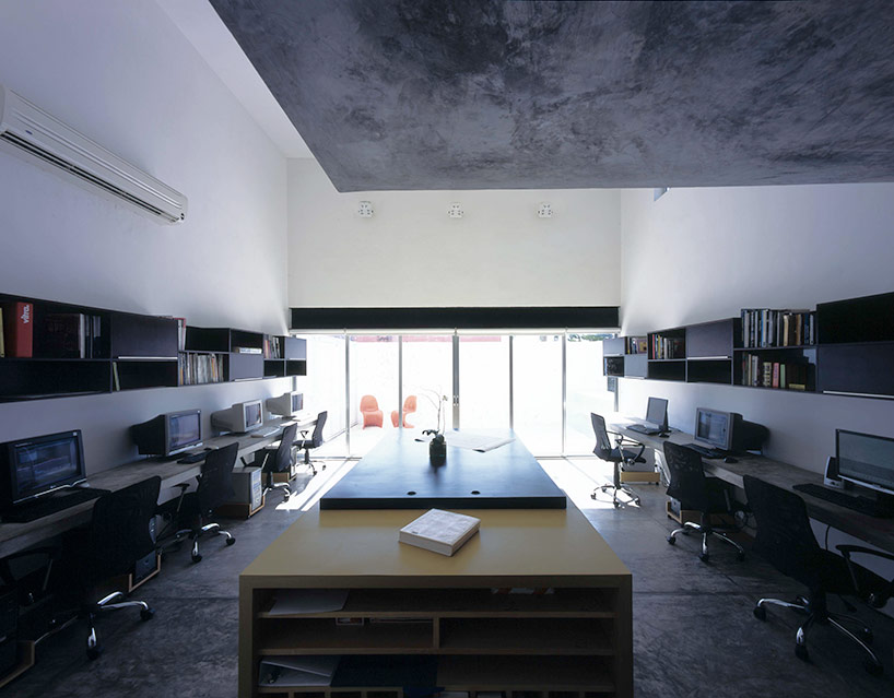 AS arquitectura fits three different offices into a concrete cube