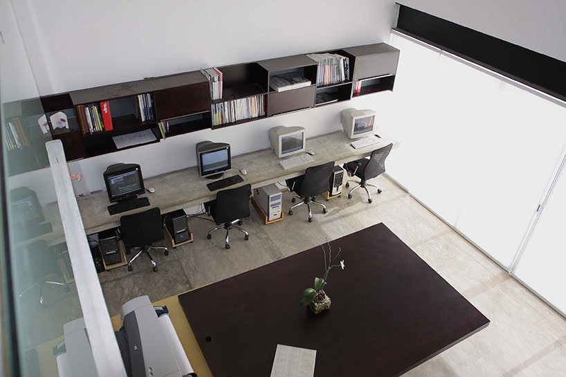 AS arquitectura fits three different offices into a concrete cube