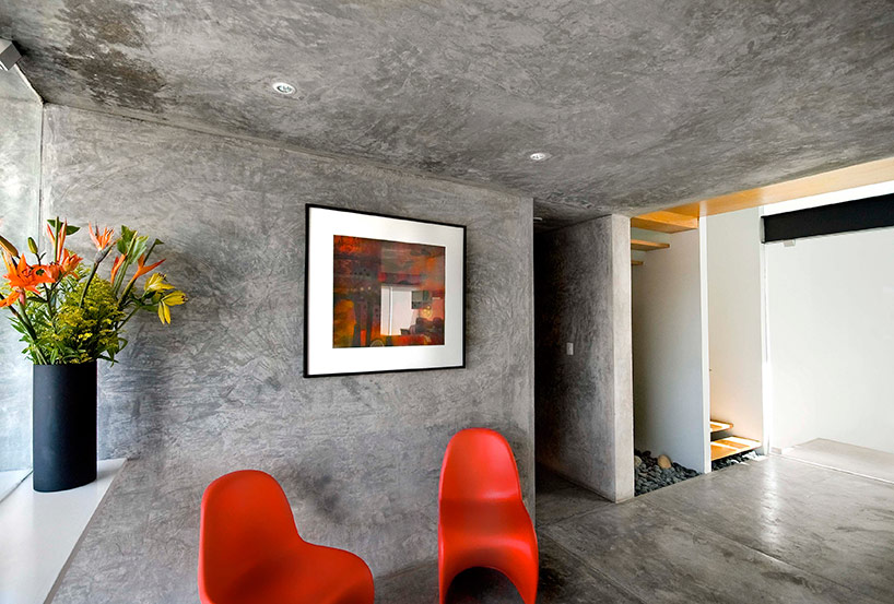 AS arquitectura fits three different offices into a concrete cube