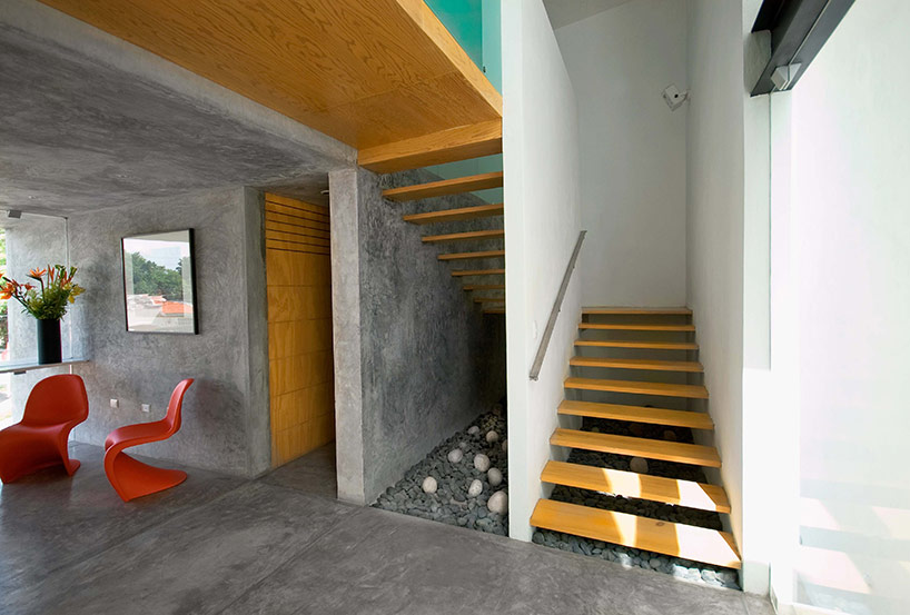 AS arquitectura fits three different offices into a concrete cube