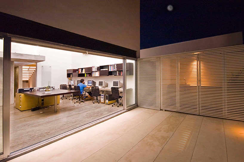 AS arquitectura fits three different offices into a concrete cube