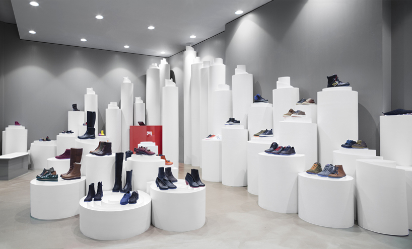 nendo's rolled paper-like pillars present shoes at camper stockholm