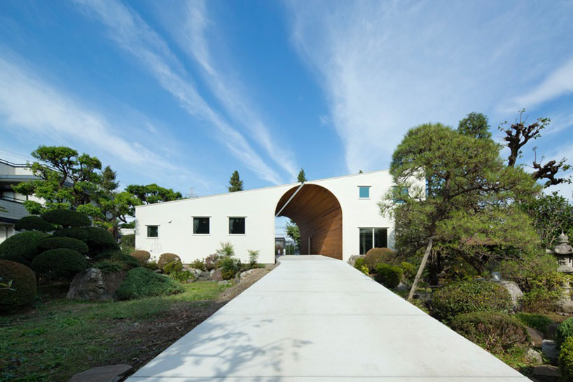 timber clad archway connects family homes by naf architect + design