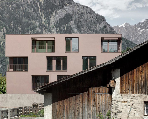 pedevilla sets pink homogenous apartment building against mountainous backdrop
