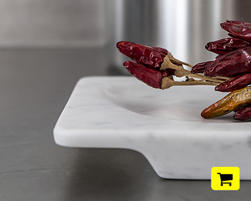 'veneri' dishes crafted from carrara marble project subtle elegance