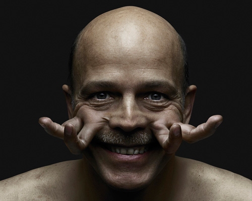 hybrid-human figures sprout fingers and hands from their faces