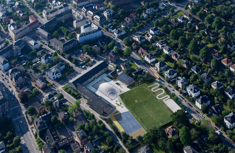 bjarke ingels expands gammel hellerup school beneath a lifted football field