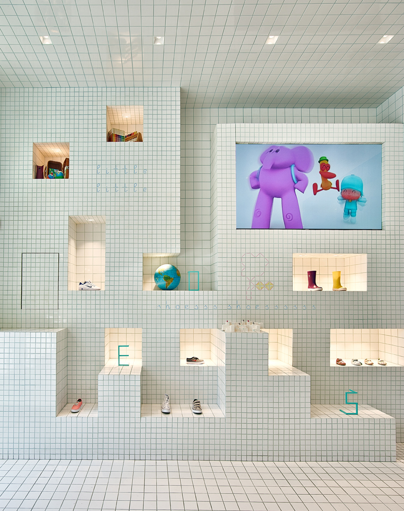nabito architects covers children's shoe shop in barcelona with a grid of tiles