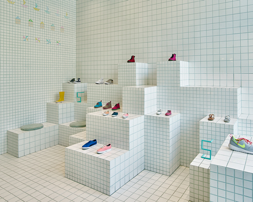 nabito architects covers children's shoe shop in barcelona with a grid of tiles