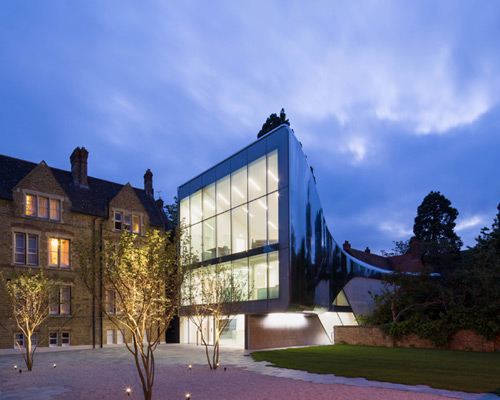 zaha hadid bridges oxford university campus with reflective library