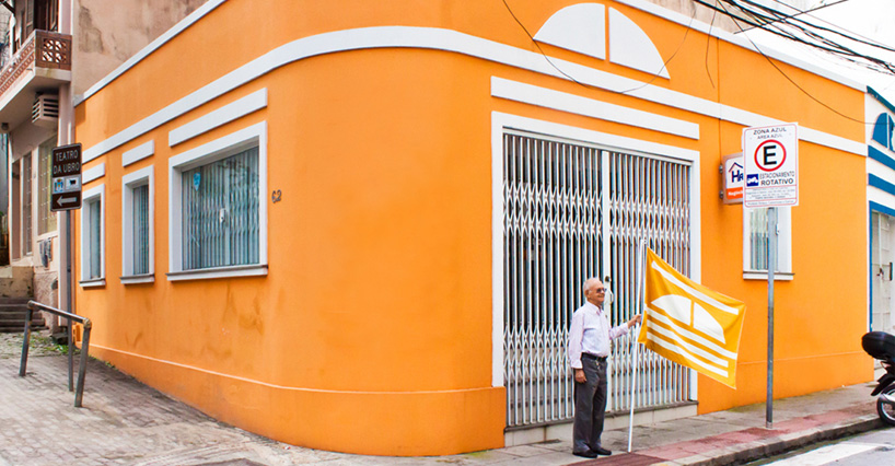 THONIK + pieke bergmans model flags on traditional brazilian homes