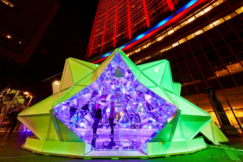 kaleidoscopic origami dome bathes visitors in luminous reflections