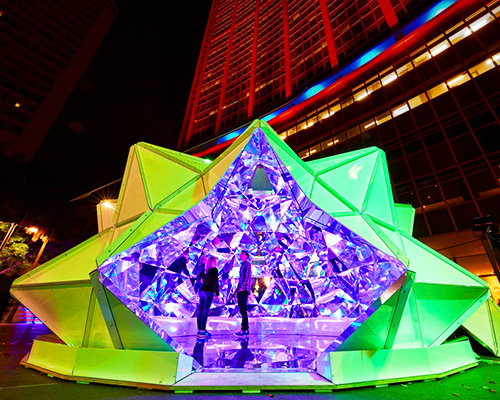 kaleidoscopic origami dome bathes visitors in luminous reflections