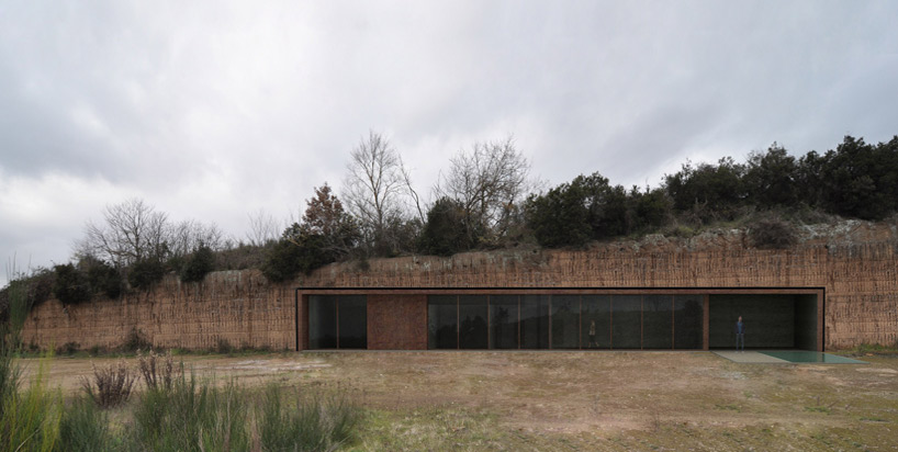 house in the rock by romano adolini emerges from abandoned quarry bluff