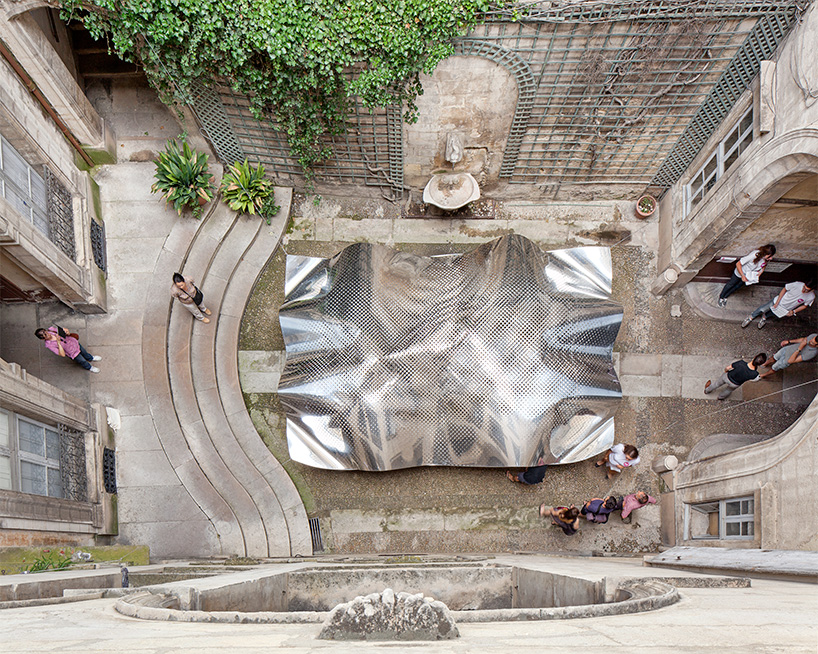 FAKT hovers an undulating aluminium cloudscape within a french courtyard