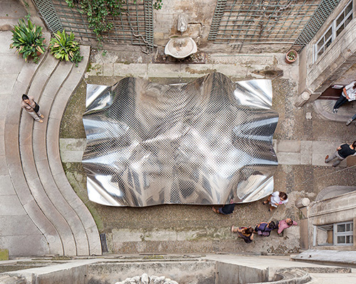 FAKT hovers an undulating aluminium cloudscape within a french courtyard