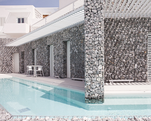 A31 architecture wraps relux hotel with gabion walls on greek island