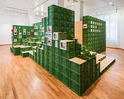 yalla yalla! adds a pine exhibition wall to a textile showroom
