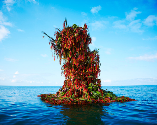 azuma makoto floats a four-meter floral sculpture into the ocean