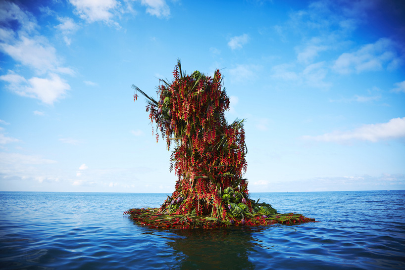 azuma makoto floats a four-meter floral sculpture into the ocean