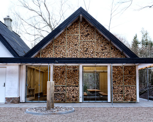 LUMO architects adds log house to rural danish recreational center