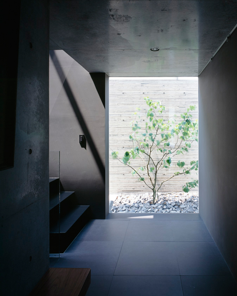 apollo architects forms garage with an overhang in minimalistic grigio ...