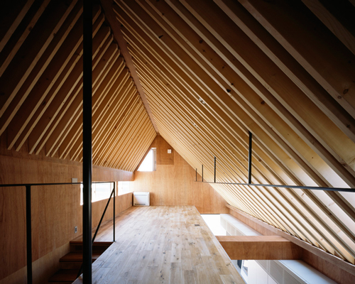 apollo architects enhances nord house's asymmetric ceiling with exposed timber rafters