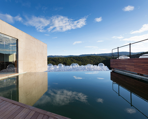 BCMF + MACH architects interweaves bar-pool-gallery on brazilian hilltop