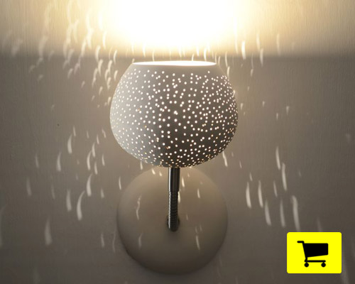 clay light sconce employs perforated shade for starry effects