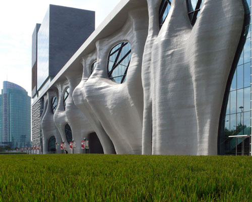 arata isozaki sculpts shanghai himalayas center with organic cave-like façade