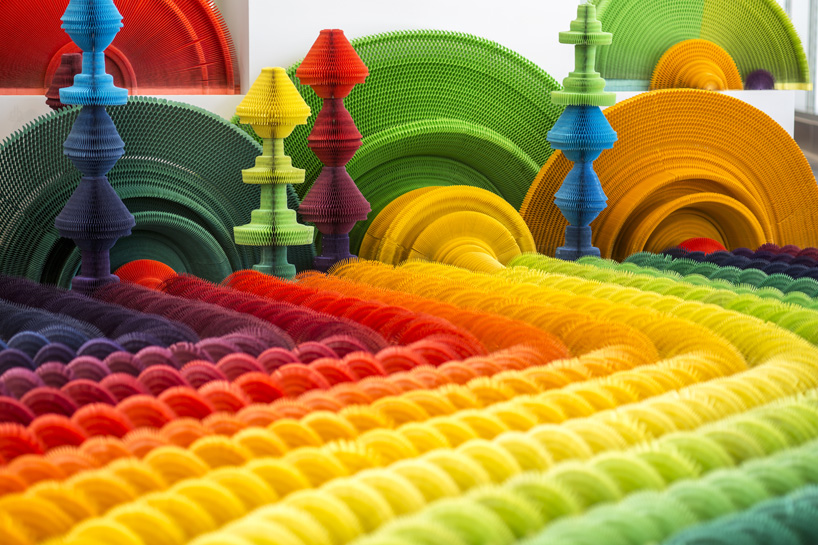 li hongbo examines the conflict of war + weapons with colorful paper gun accordions