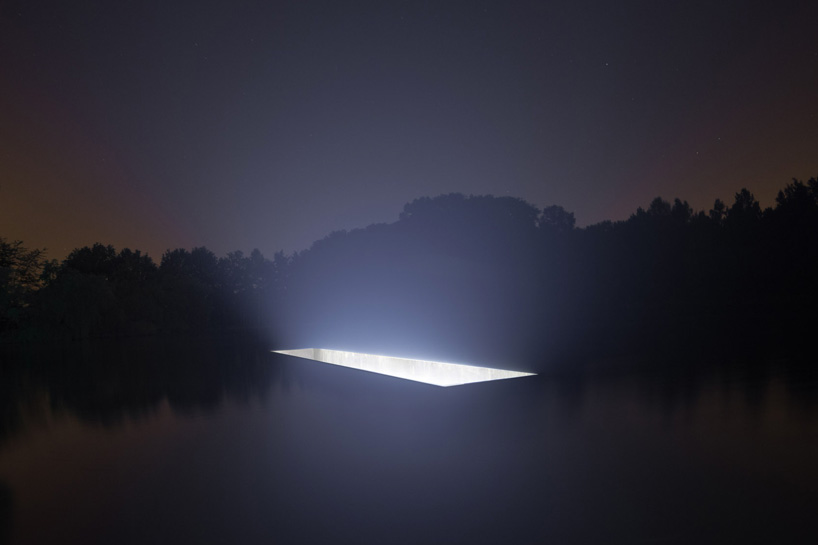 88888 sculpts luminous void within the water surrounding the castle of horst