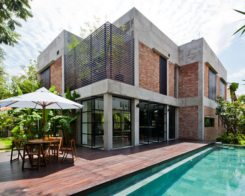 MM++ architects wraps vietnamese villa with pivoting glass doors