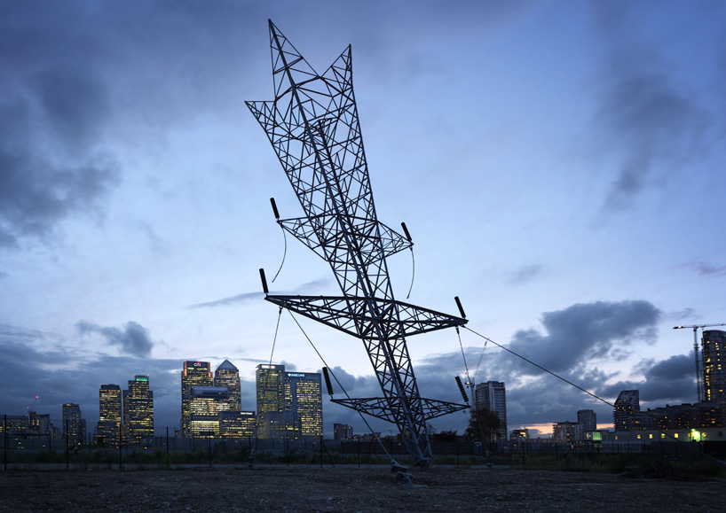alex chinneck spears inverted electricity pylon into london's greenwich peninsula