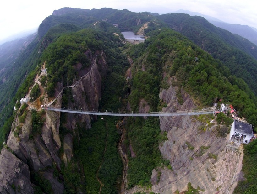 glass suspension bridge spans between two cliffs in china's shiniuzhai park