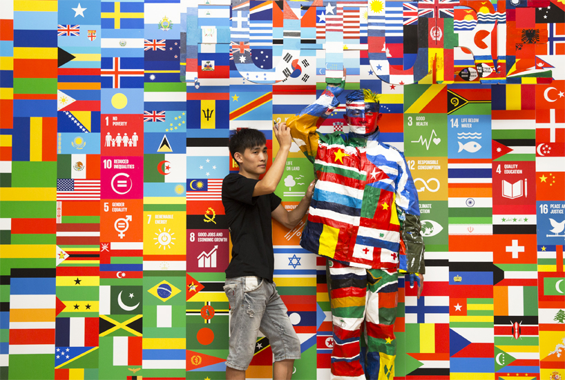 liu bolin camouflages himself against 193 UN flags for the global goals campaign