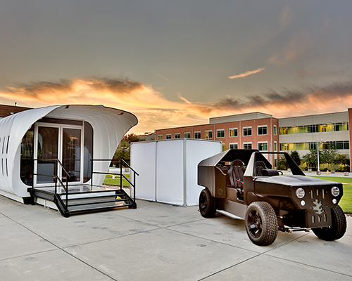 3D printed vehicle and SOM-designed building power each other wirelessly
