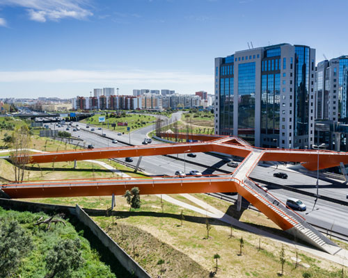 maximina almeida + telmo cruz overlap orange steel bridge above highway in lisbon
