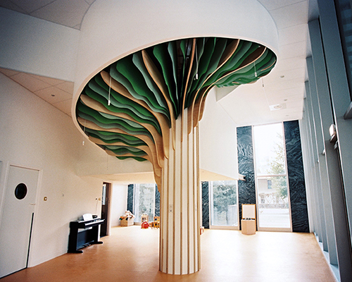 studio millimètre installs six meter high tree in paris nursery