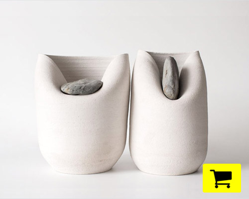 clay vase folds dynamically under the weight of a colera stone