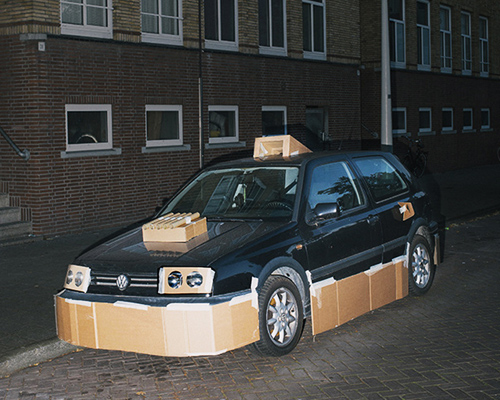 artist pimps out strangers cars at night with cardboard and tape