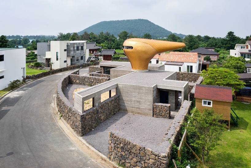 moon hoon installs a golden beak-shaped tower atop his wind house residences