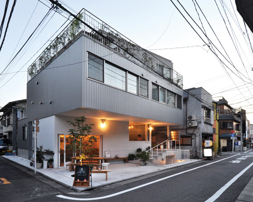 naka architects' studio merges apartments, office and restaurant into one building