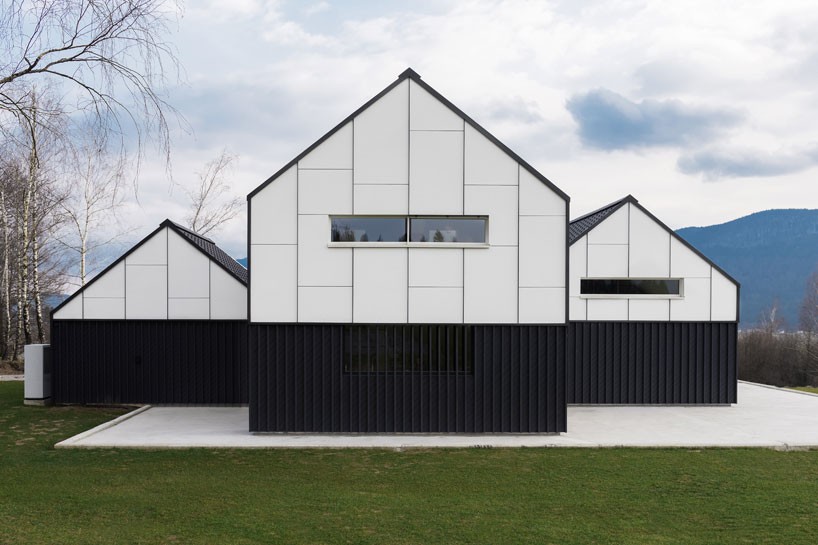 sono architects sets monochromatic, gabled volumes in rural slovenia