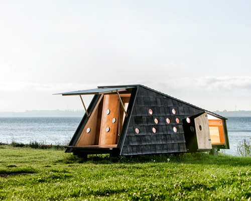 LUMO architects scatters asymmetric nature shelters along the danish archipelago