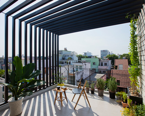 narrow townhouse in vietnam by MM++ features a retractable shutter screen