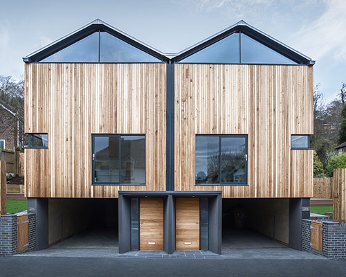 adam knibb architects converts garage into twin cedar lodges