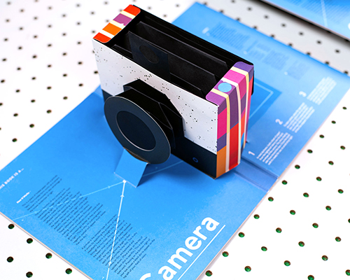 kelli anderson cuts and folds paper into pop-up book pin hole camera